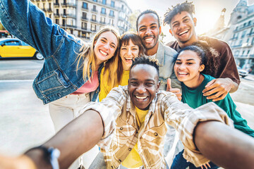 Multiracial best friends taking selfie walking on city street - Happy young people having fun enjoying day out - Diverse teens laughing at camera on summer vacation - Friendship and tourism concept © Davide Angelini