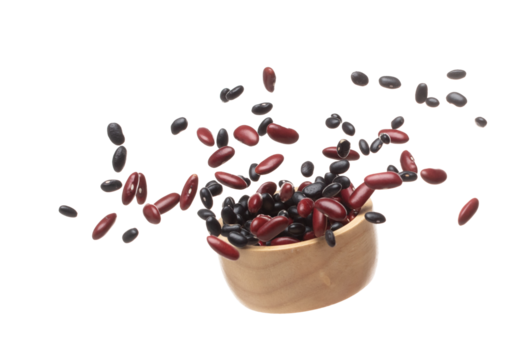 Mix black red beans fall down explosion, several kind bean float explode in wooden bowl. Dried red black mixed beans splash throwing in Air. White background Isolated high speed shutter, freeze motion