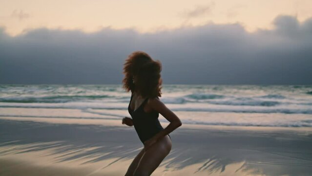 Girl performer dancing seashore at summer evening. Woman moving body smoothly.