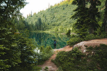 A woman standing in front of Snow Lake in Mount Rainier National Park