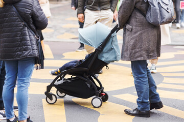 woman with a stroller walking in the city