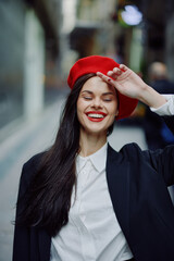 Fashion woman smile with teeth portrait stroll tourist in stylish clothes with red lips walking down narrow city street curves, travel, cinematic color, retro vintage style, Valentine's Day.