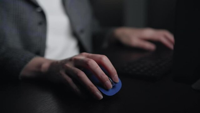 暗い部屋でパソコンを使う女性