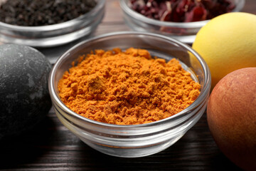 Painted Easter eggs with natural organic dyes (turmeric, hibiscus, tea) on wooden table, closeup