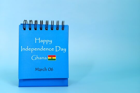 Happy Independence Day Ghana  greeting on blue desk calendar with flag icon. National day celebration concept.