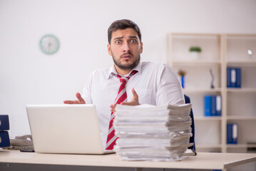 Young male employee working in the office