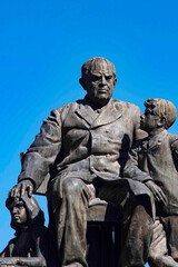 Fototapeta premium Monument of Domingo Fautino Sarmiento seated with two children in the Plaza 25 May made in bronze by the sculptor Victor de Pol San Juan Argentina