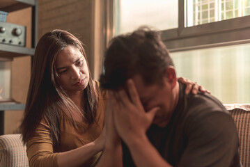 A concerned wife comforts her husband who breaks down and cries. Being there for a partner during...