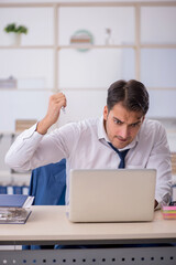 Fototapeta premium Young male employee and too much work in the office