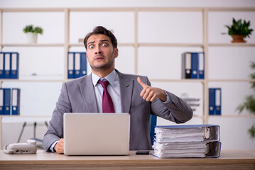 Young male employee working in the office