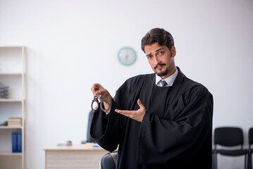 Young male judge working in the courthouse