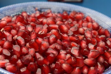 Close up of a bowl of loose, fresh pomegranate seeds