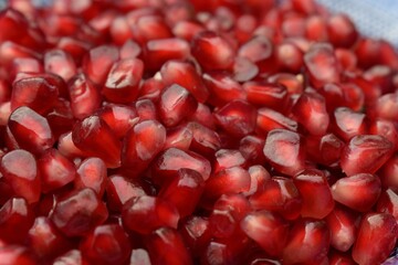 Close up of a bowl of loose, fresh pomegranate seeds