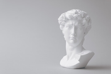 Gypsum statue of David's head. Michelangelo's David statue plaster copy isolated on white background. Minimal concept of Ancient greek sculpture, statue of hero