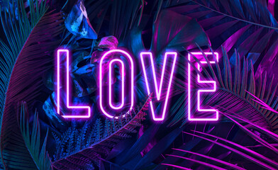 Trendy composition made of fluorescent color layout made of tropical jungle leaves. Flat lay neon colors in the shape of the word "LOVE" . Nature concept. Creative art, minimal aesthetics. © Vidic Bojan