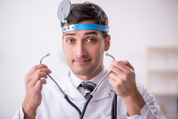 Young male doctor otolaryngologist working in the clinic