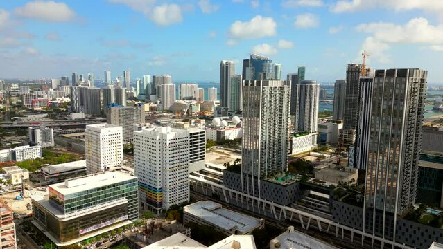 Aerial stock video Downtown Miami skyscrapers. Drone flying past city on nice vibrant day