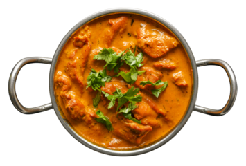 indian butter chicken curry in balti dish top down view and isolated with cilantro garnish