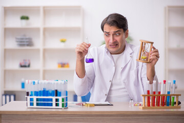 Young male chemist working at the lab