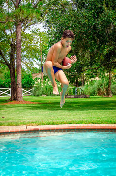 Youth Male Boy Teen Jumping Into Swimming Pool With Ball