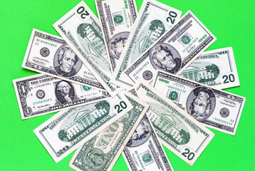 Flat lay of dollar bills on green backdrop. Financial business background. Banking concept, payment for services, pension payments, market, loans, economy, inflation, tax. Top view, close-up, mock up