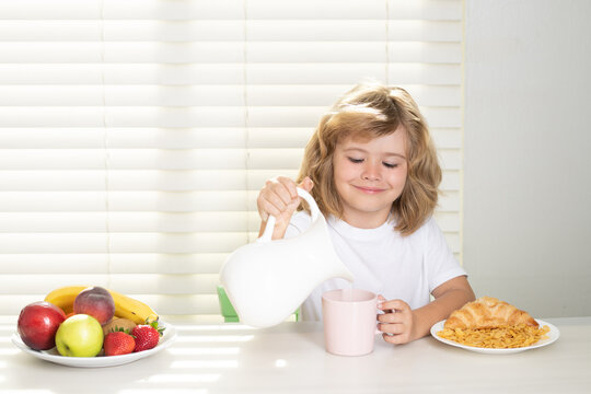 Pretten child pouring whole cows milk. Kid bot eating meal. Healthy nutrition for children. Child enjoy eating for breakfast or dinner with appetite. Hungry child eat tasty fruits and vegetables.
