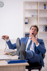 Young male employee working in the office