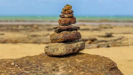 Fototapeta na wymiar rock pyramid on beach
