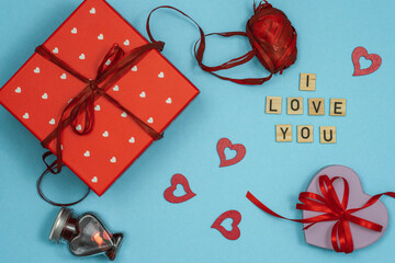 Composition for Valentine's day. Celebrating Valentine's. 
Flat lay style, top view. Saint Valentine day background with gift box and various red hearts and red roses - obrazy, fototapety, plakaty