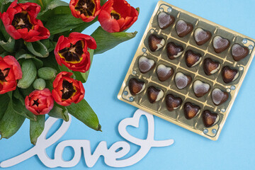 Composition for Valentine's day. Celebrating Valentine's. 
Flat lay style, top view. Saint Valentine day background with gift box and various red hearts and red roses - obrazy, fototapety, plakaty