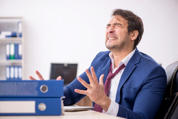 Young male employee working in the office