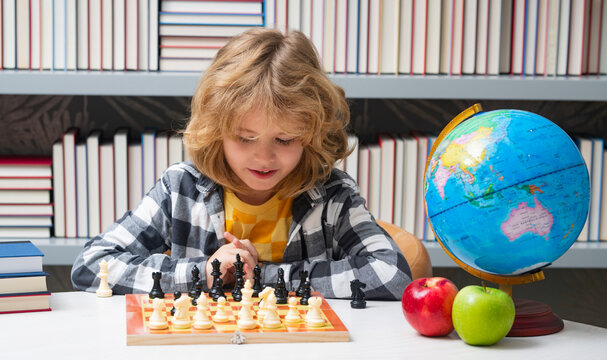 Chess school. Clever concentrated and thinking child playing chess. Child boy developing chess strategy, playing board game.