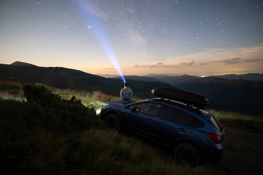 Silhouette Of Man At Offroad Car With Head Flashlight On Background Of Very Beautiful Night Starry Sky After Sunset. Freedom And Travel By Car Concept