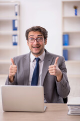 Young male employee working in the office