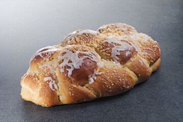 Freshly baked challah on a stone table. Usually braided and typically eaten on ceremonial occasions such as Shabbat and major Jewish holidays
