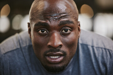 Face, portrait and sweating black man tired after exercise, workout or training resting after...