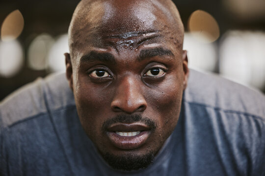 Face, portrait and sweating black man tired after exercise, workout or training resting after exercising in gym. Sports break, wellness and male athlete from Nigeria with fatigue, exhausted and sweat - Powered by Adobe