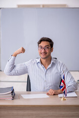 Fototapeta premium Young male english language teacher in the classroom