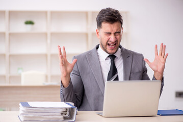 Young male employee working in the office