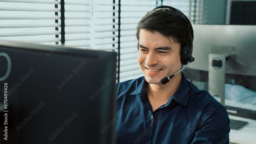 Aufkleber young competent asian male call center agent working at his computer while simultaneously speaking w