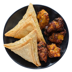 indian samosas and pakoras on plate shot from top down view and isolated