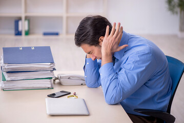 Young male employee and too much work in the office