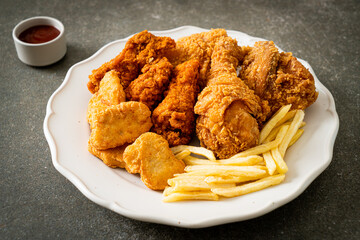 fried chicken with french fries and nuggets on plate