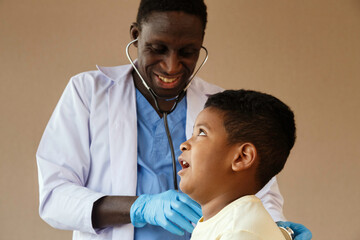 african american pediatrician doctor using stethoscope to examining boy from sickness in office at...