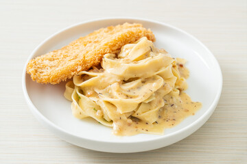 fettuccine pasta white cream sauce with fried fish