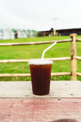 americano coffee on wood table with Mountain hill View background
