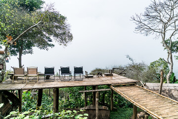 chair on balcony with mountain hill and foggy background