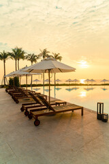 umbrella with bed pool around swimming pool with ocean sea background