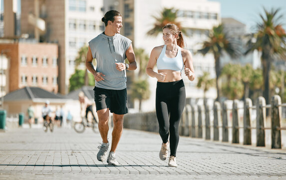 Couple, Running And Training Together In The City For Exercise, Workout Or Cardio Routine In Cape Town. Happy Man And Woman Runner In Fitness, Walk Or Jog For Healthy Wellness Or Exercising Outside