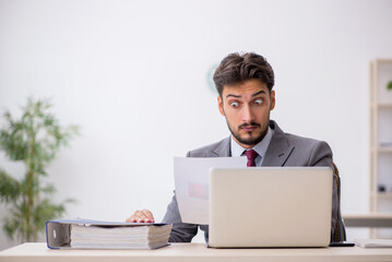 Young male employee working in the office